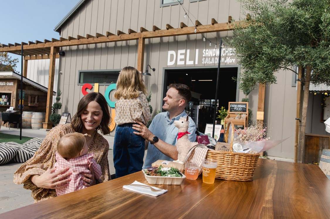 a family sitting outside enjoying a meal together