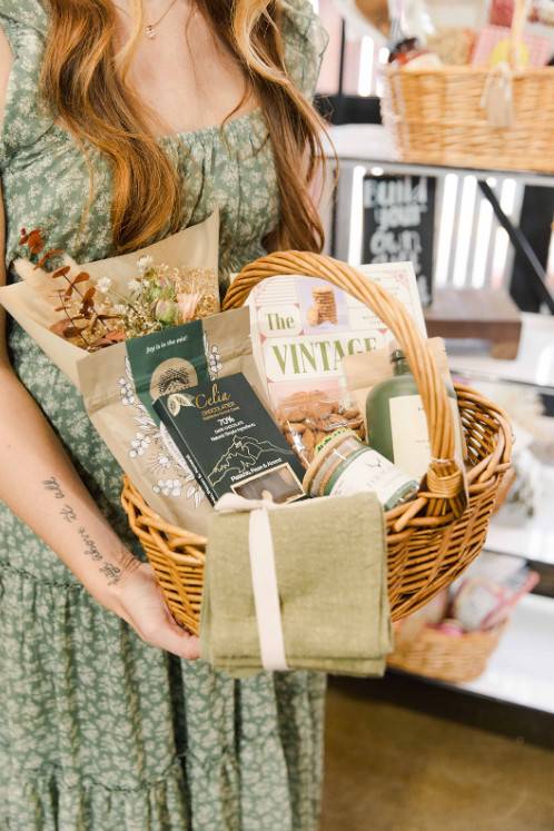 a woman holding a giftbasket